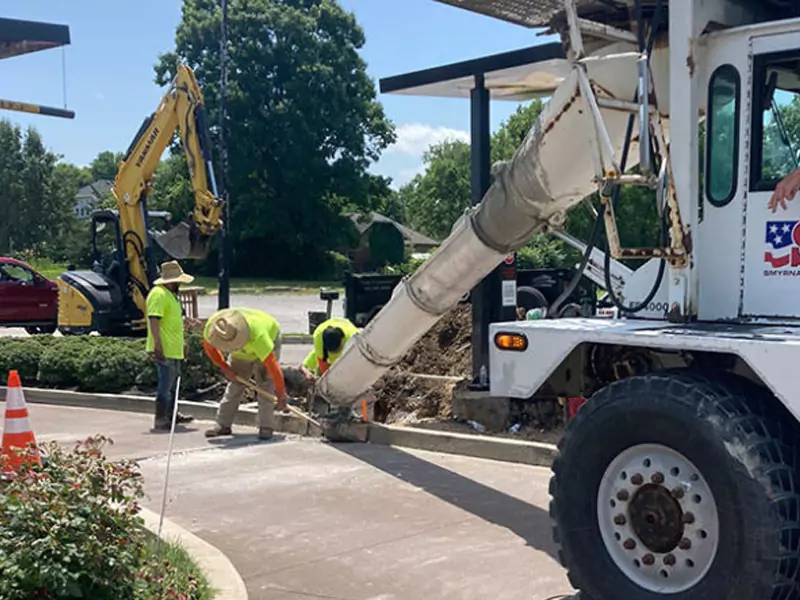 Photo of concrete curb being repaired